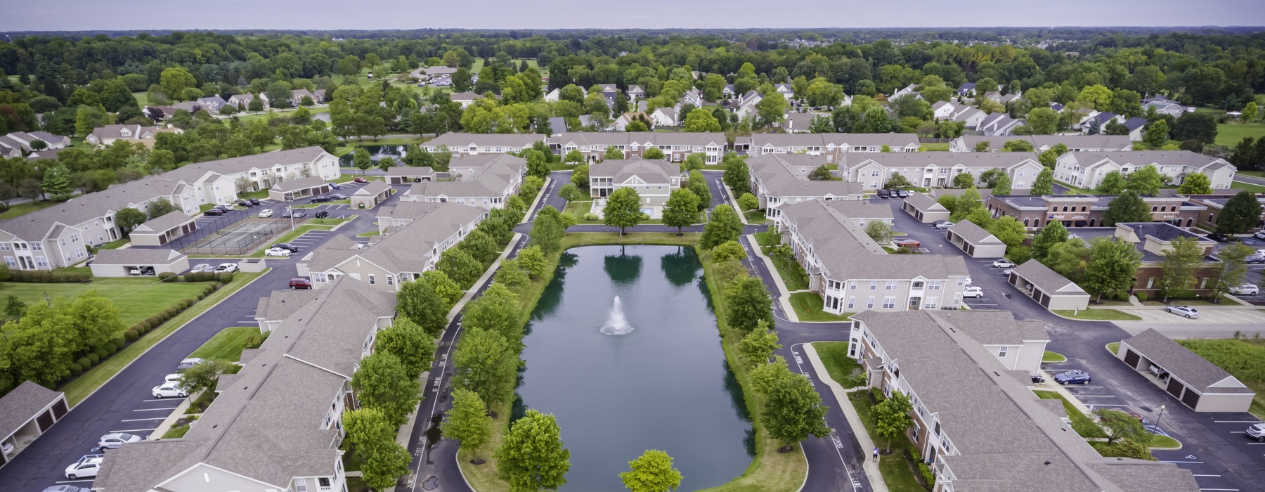 Aerial view of pond and apartment buildings