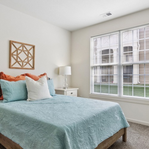 bedroom with white walls and big window