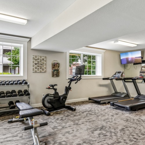 fitness center with elliptical, treadmill, and weight machines